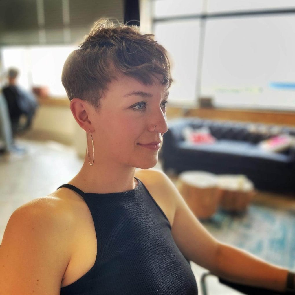 Playful wavy pixie with soft front bangs.