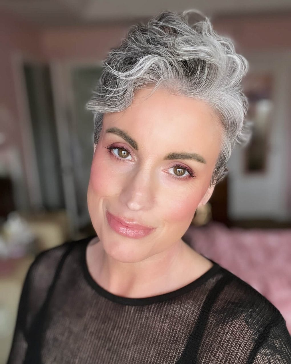 Short wavy salt and pepper haircut enhancing facial features