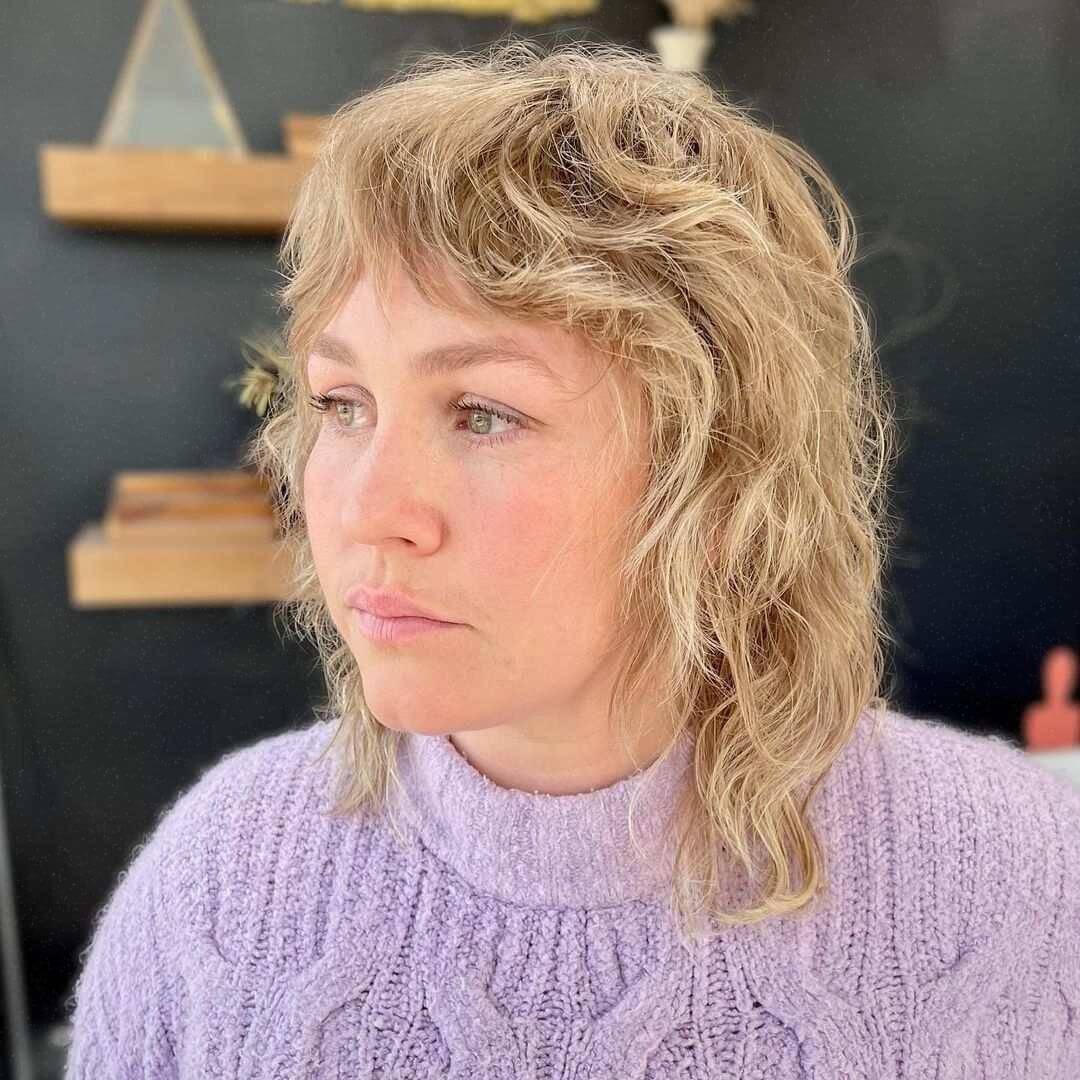 Wavy textured shag cut with blonde curtain bangs