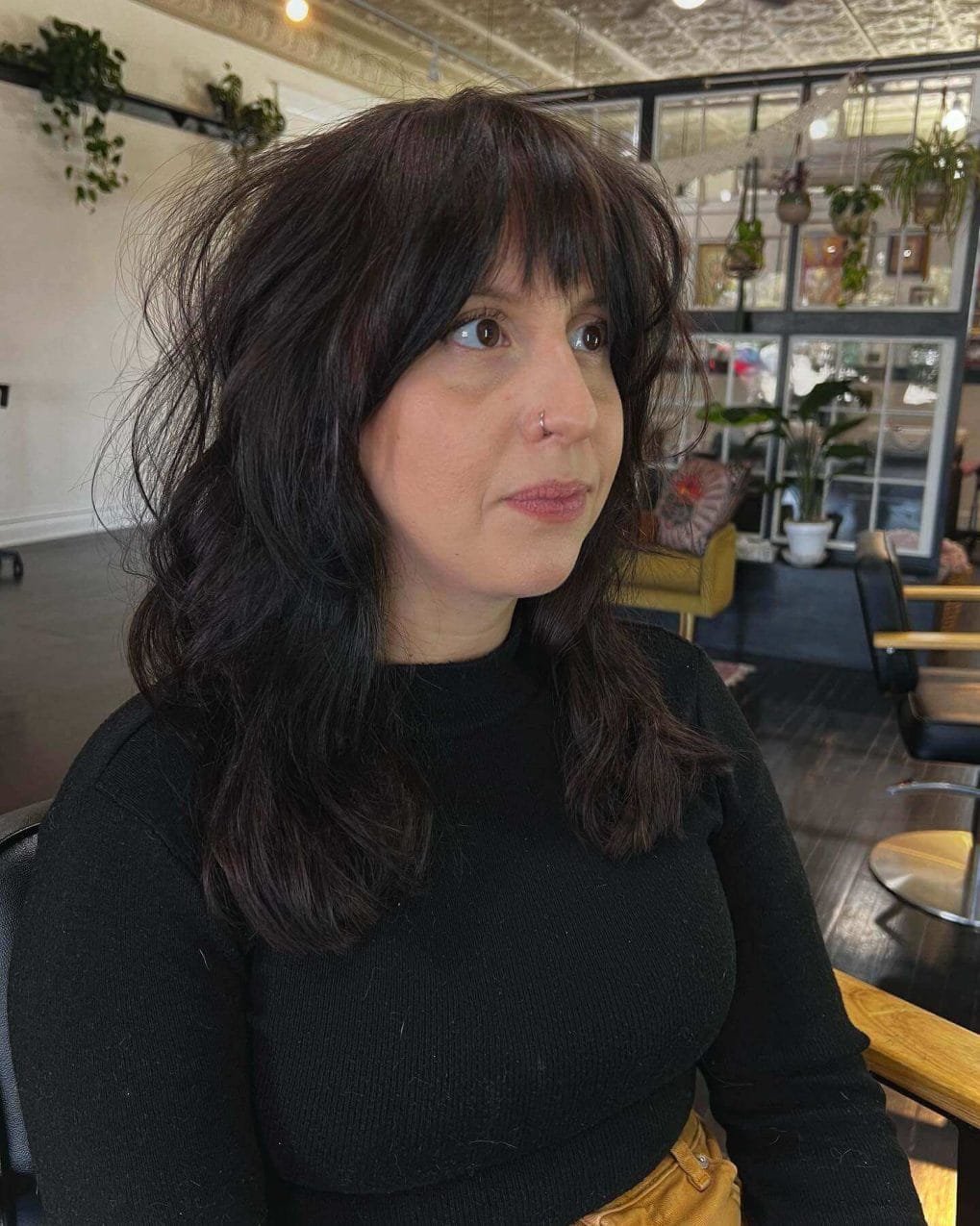 Casual elegant wavy hair with stylish mixed feathered bangs.