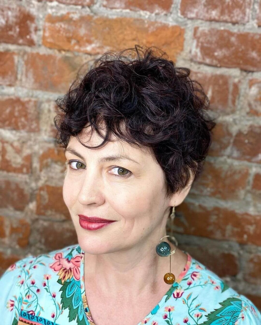 Wavy pixie with rich Bordeaux highlights.