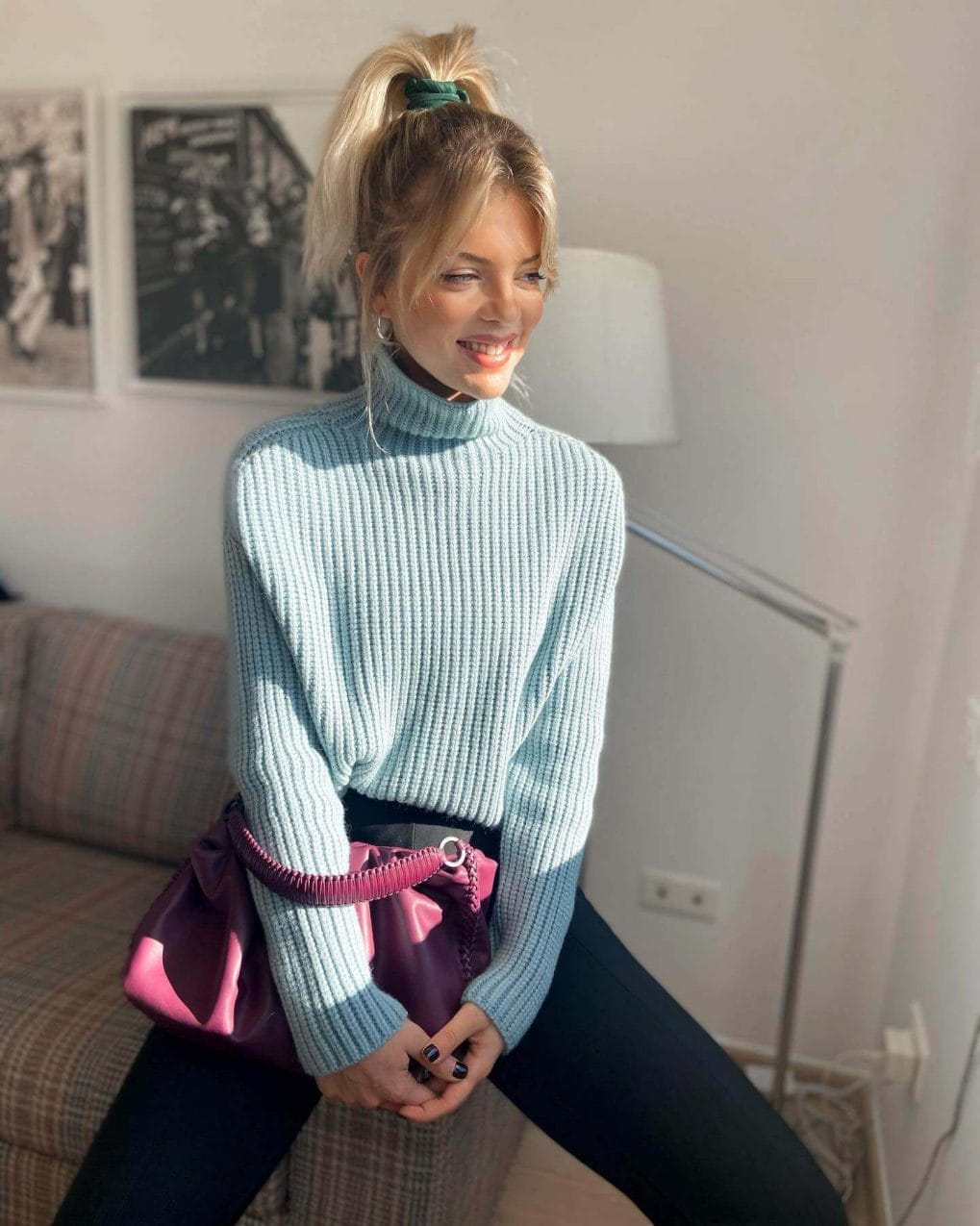 Spirited high ponytail in soft honey-blond secured with a vibrant scrunchie, featuring loose strands for casual elegance.